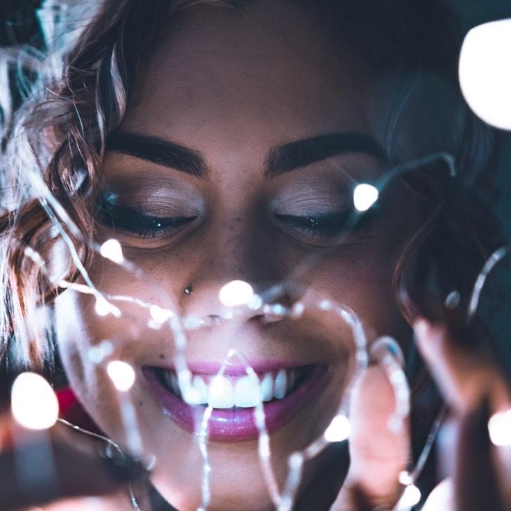 Kaveri Mehta, Lead Design Curator at BeaconFieldHarbor, reviewing corporate floral arrangements